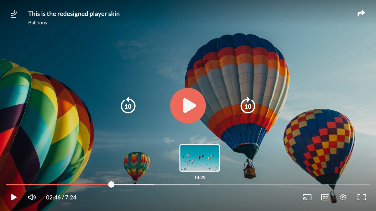 The redesigned player skin on a video of hot-air balloons, with large controls and a thumbnail preview.